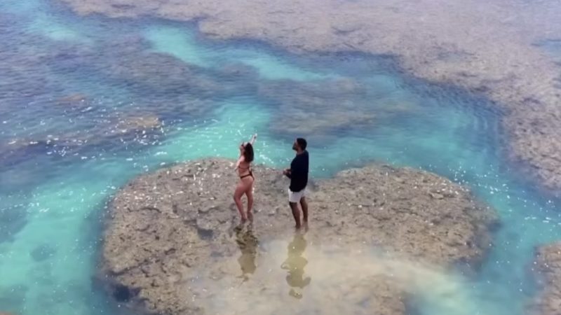 Pedido de casamento em ilha em formato de coração emociona casal em Maceió